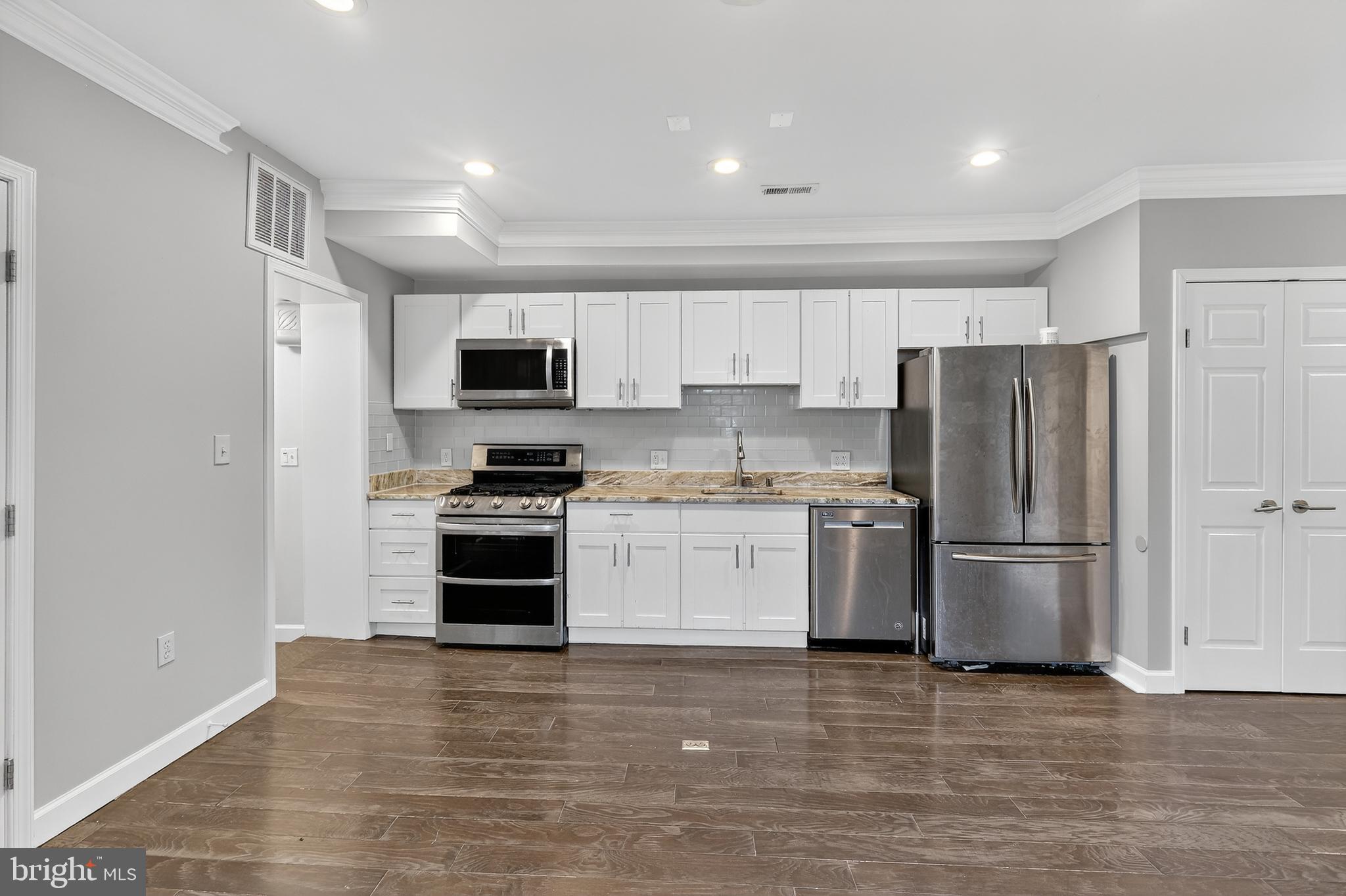 5619 1st Place Northwest, Unit 4 Washington, DC 20011 - Photo 7 of 24 a kitchen with a refrigerator stove and microwave