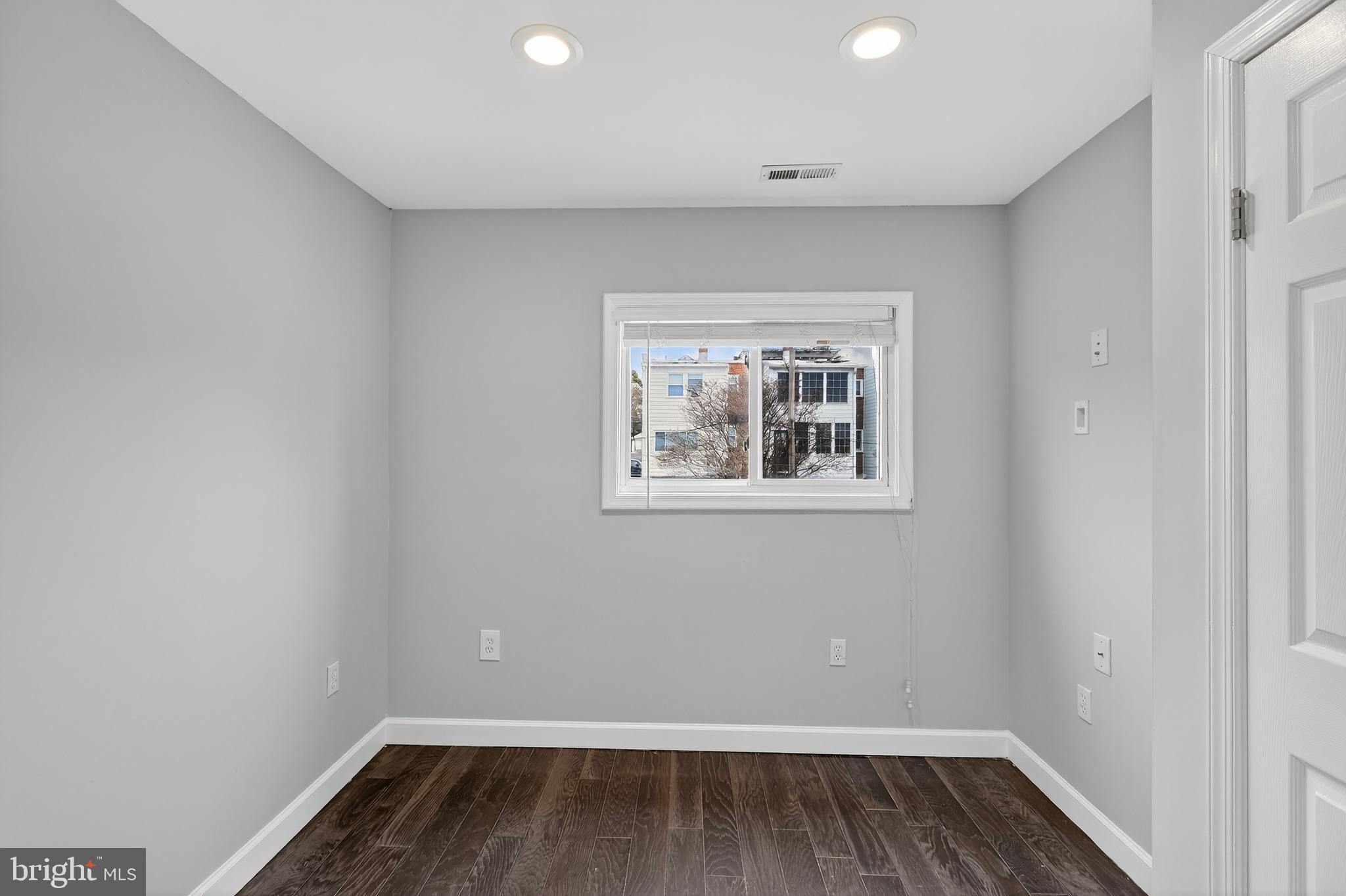 5619 1st Place Northwest, Unit 4 Washington, DC 20011 - Photo 9 of 24 wooden floor in an empty room with a window