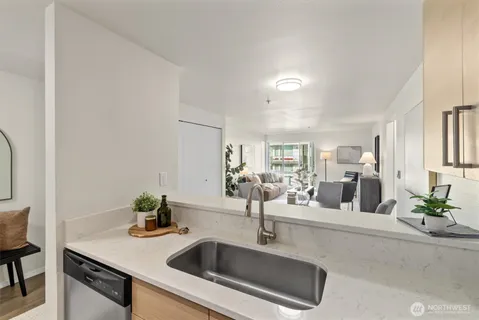 a kitchen with sink and mirror