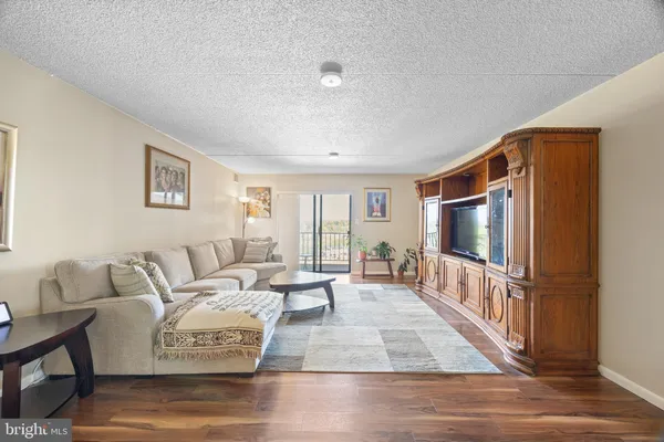 a living room with furniture windows and a flat screen tv