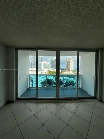 a view of an empty room with a floor to ceiling window
