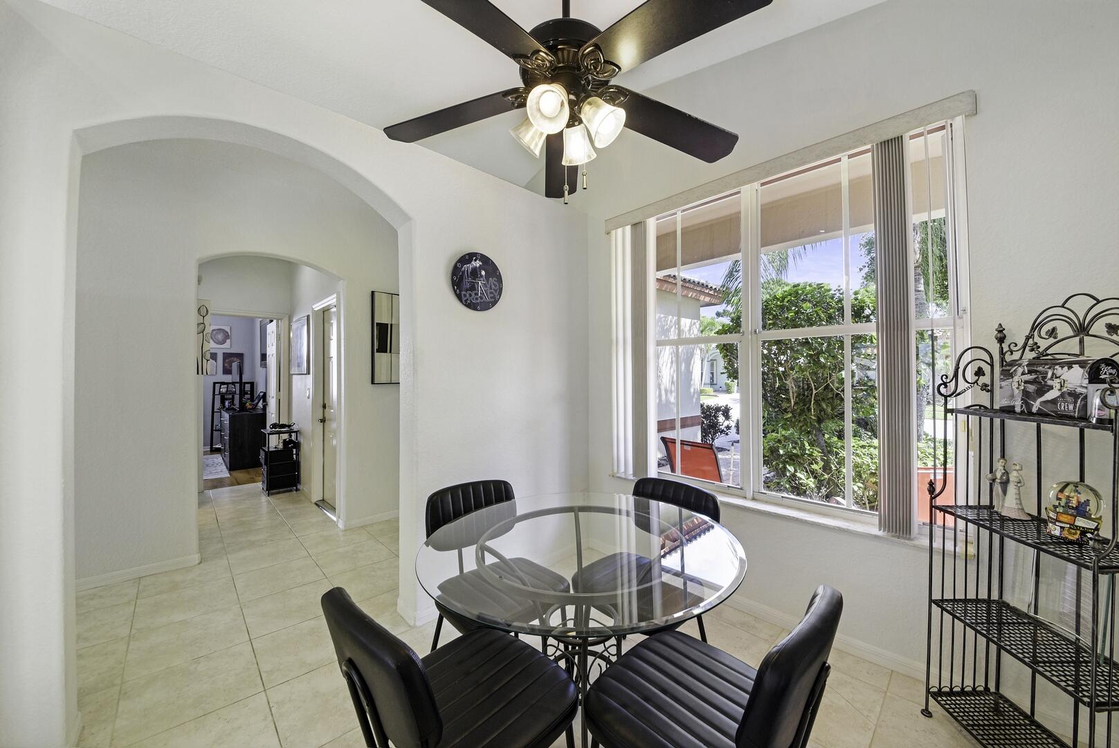 8214 Bellafiore Way Boynton Beach, FL 33472 - Photo 9 of 35 a dining room with furniture a chandelier and a rug