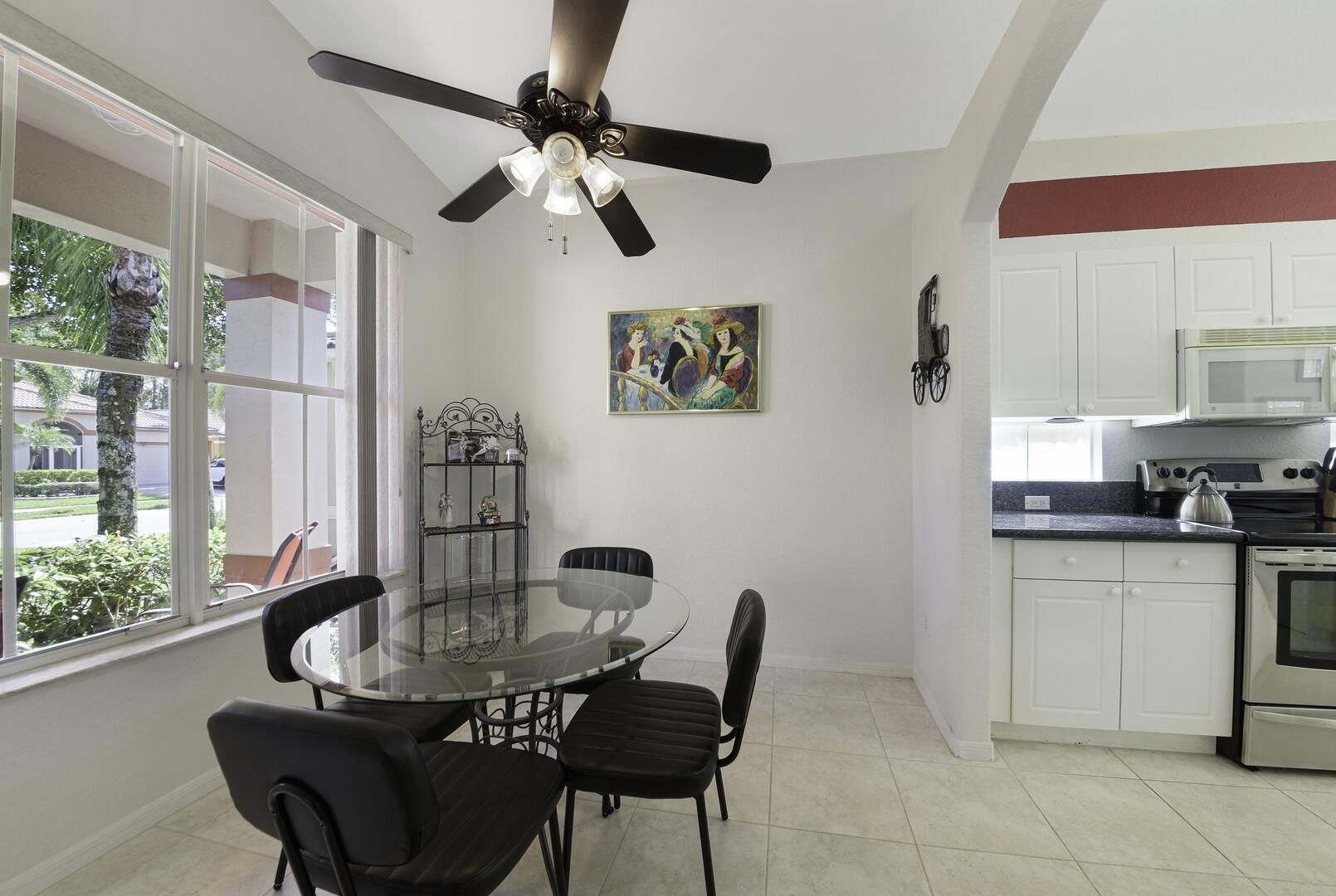 8214 Bellafiore Way Boynton Beach, FL 33472 - Photo 11 of 35 a view of a kitchen with a table and chairs