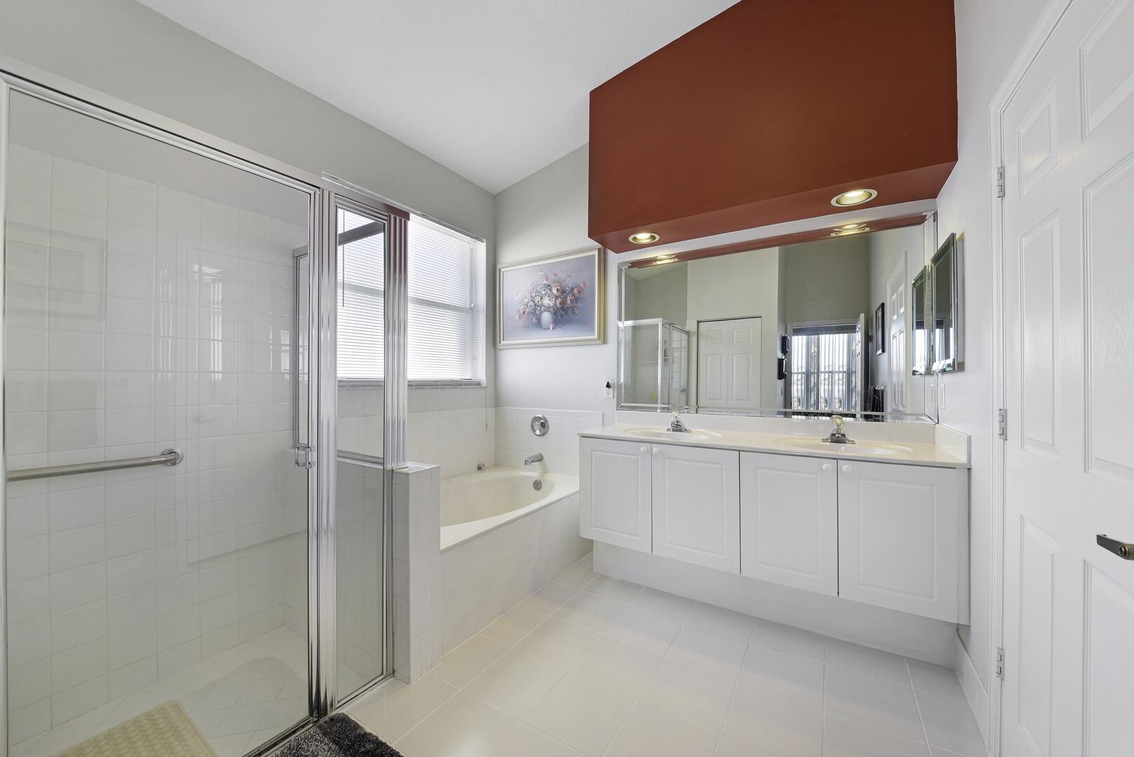 8214 Bellafiore Way Boynton Beach, FL 33472 - Photo 13 of 35 a bathroom with a tub a sink and mirror