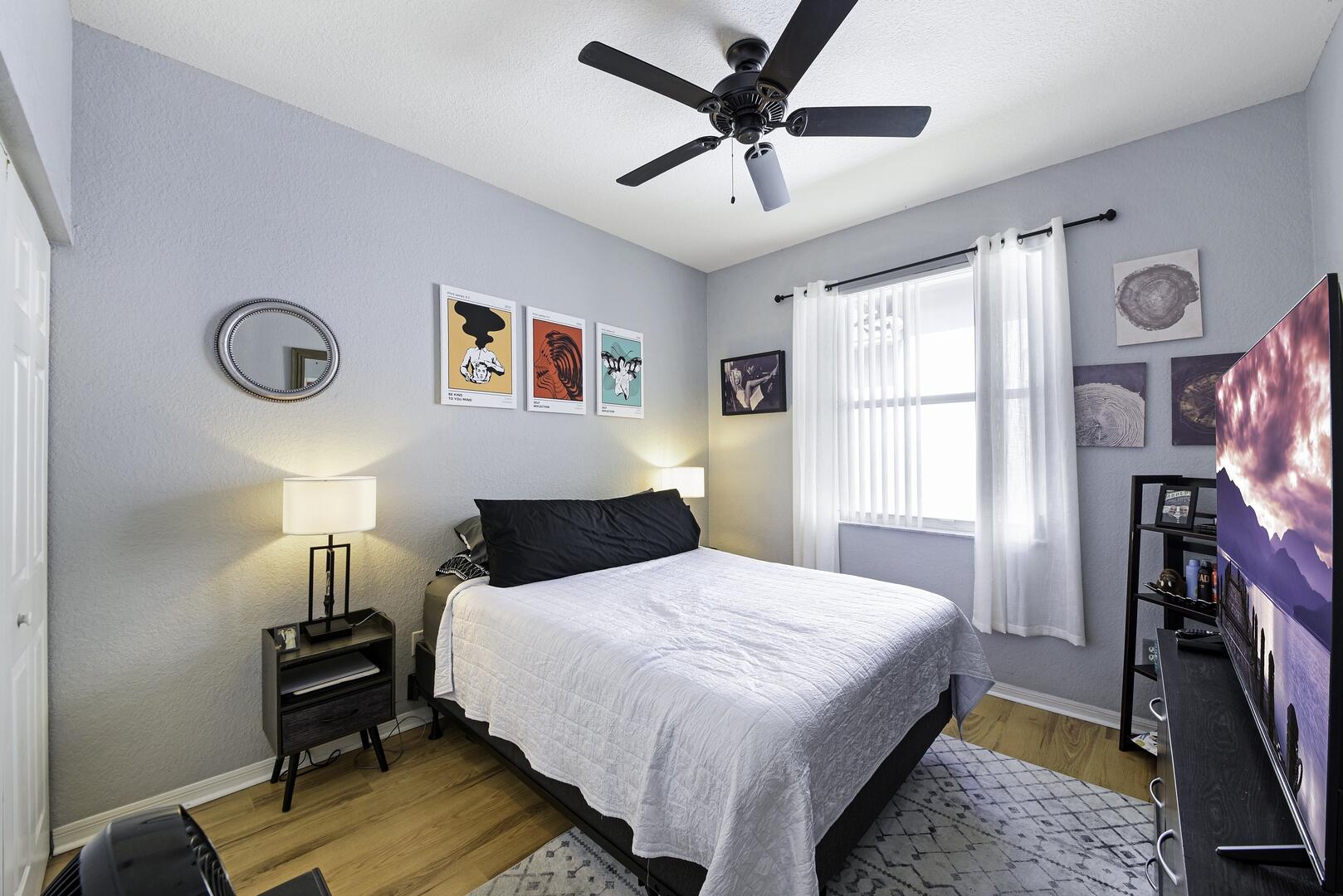 8214 Bellafiore Way Boynton Beach, FL 33472 - Photo 15 of 35 a bedroom with a bed and a chandelier