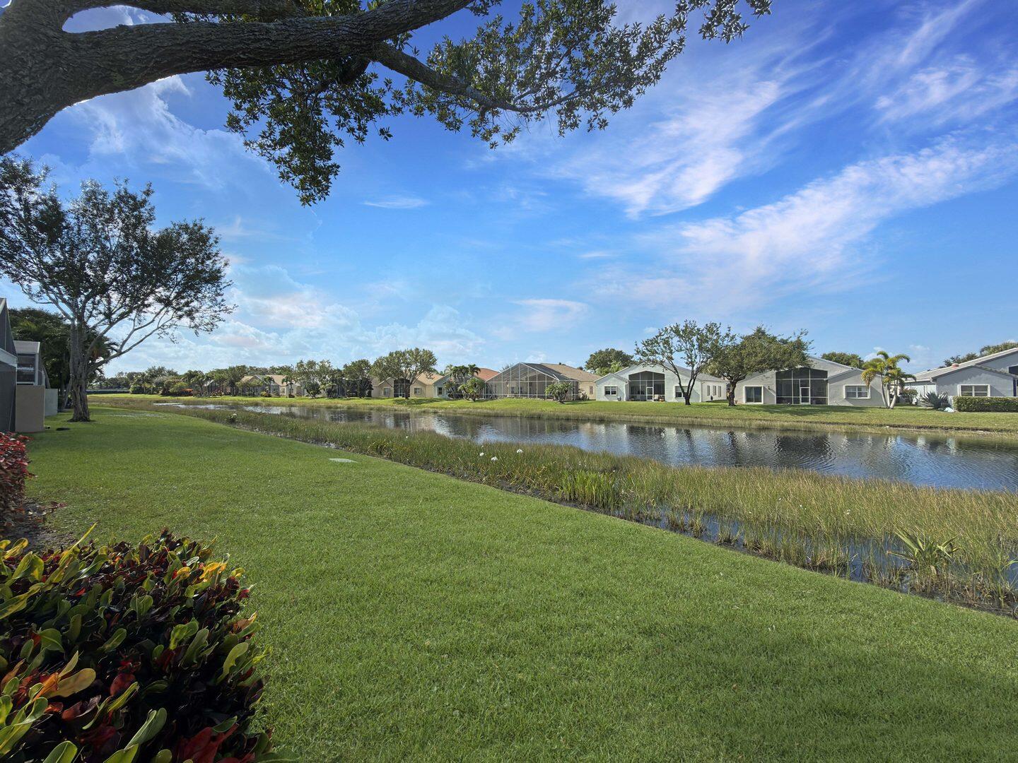 8214 Bellafiore Way Boynton Beach, FL 33472 - Photo 21 of 35 a view of a lake with houses in the back
