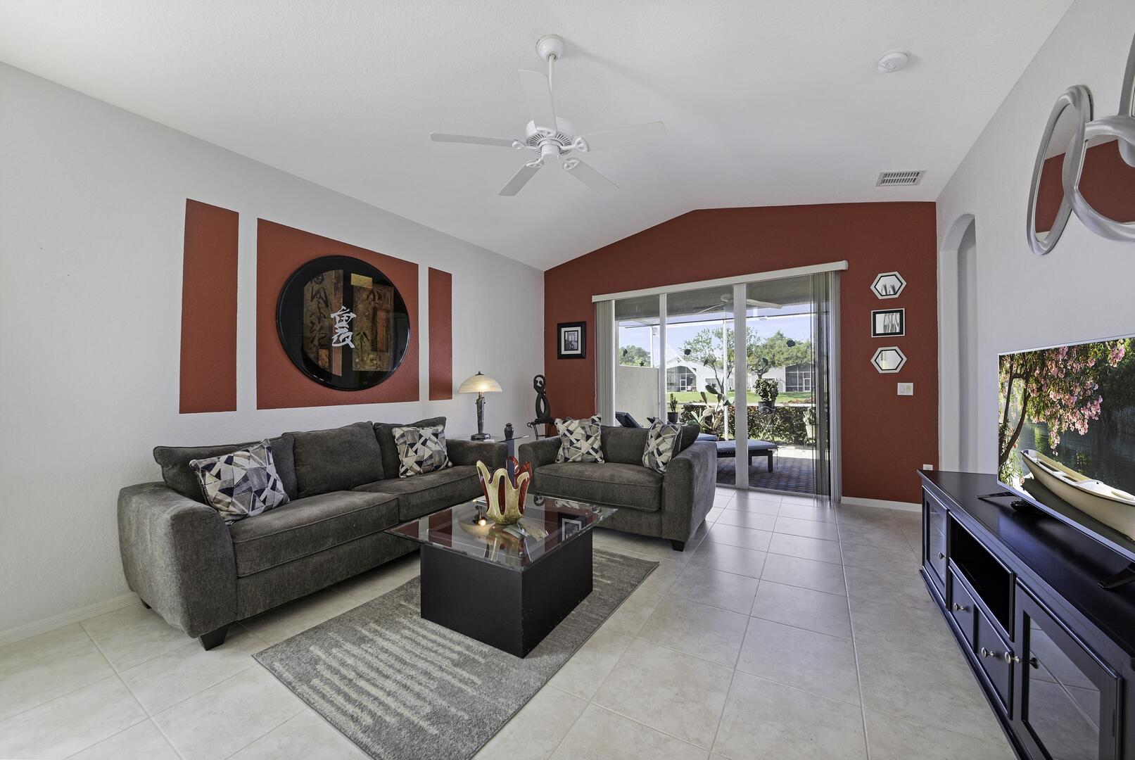 8214 Bellafiore Way Boynton Beach, FL 33472 - Photo 2 of 35 a living room with furniture a rug and a flat screen tv