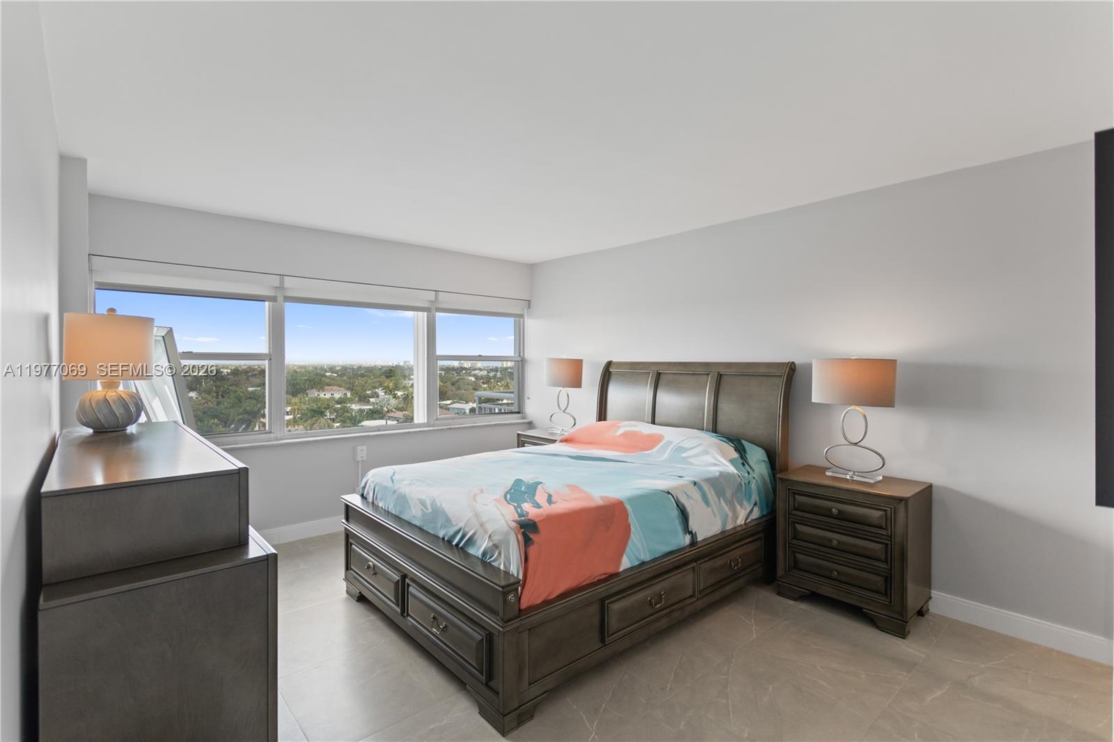 2611 North Riverside Drive, Unit 901 Pompano Beach, FL 33062 - Photo 14 of 27 a bed sitting in a bedroom next to a window
