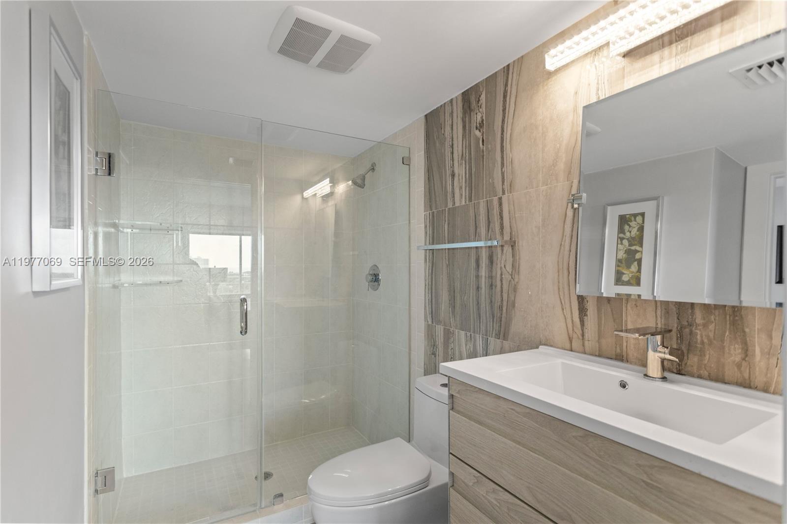 2611 North Riverside Drive, Unit 901 Pompano Beach, FL 33062 - Photo 15 of 27 a bathroom with a sink a toilet and shower