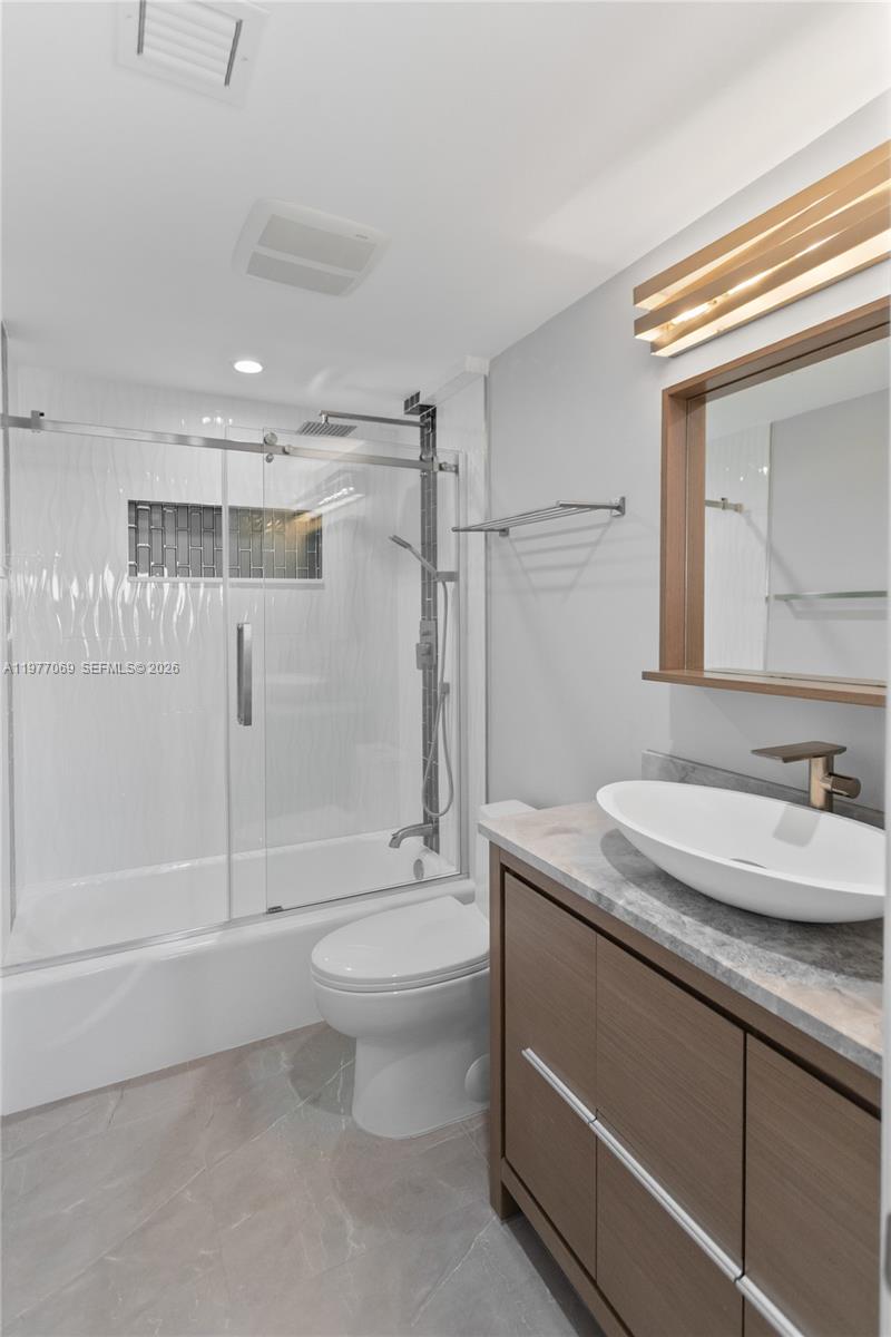 2611 North Riverside Drive, Unit 901 Pompano Beach, FL 33062 - Photo 17 of 27 a bathroom with a granite countertop sink toilet and shower