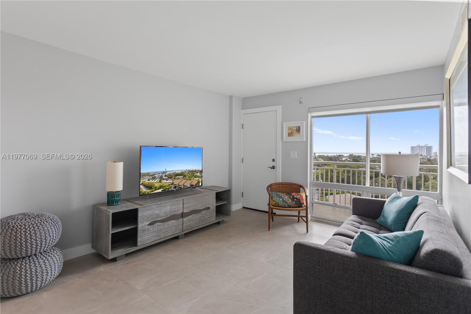 2611 North Riverside Drive, Unit 901 Pompano Beach, FL 33062 - Photo 18 of 27 a living room with furniture and a flat screen tv