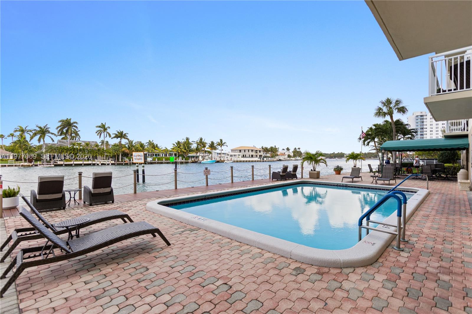 2611 North Riverside Drive, Unit 901 Pompano Beach, FL 33062 - Photo 19 of 27 a view of a swimming pool with a lounge chair