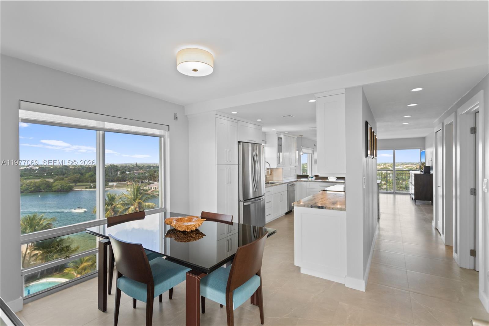 2611 North Riverside Drive, Unit 901 Pompano Beach, FL 33062 - Photo 2 of 27 a dining room with furniture and a floor to ceiling window
