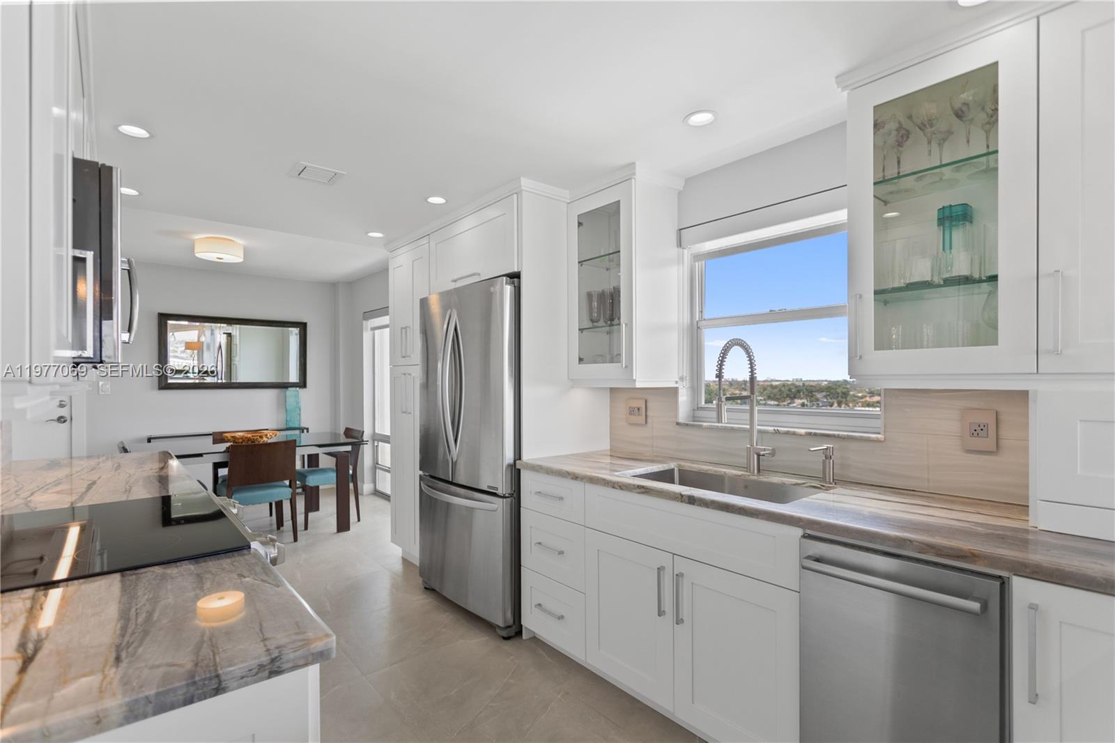 2611 North Riverside Drive, Unit 901 Pompano Beach, FL 33062 - Photo 6 of 27 a kitchen with furniture a refrigerator and a sink