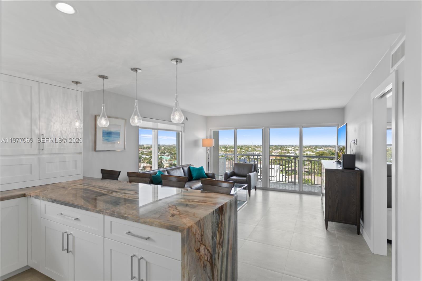 2611 North Riverside Drive, Unit 901 Pompano Beach, FL 33062 - Photo 7 of 27 a kitchen with a large window appliances and cabinets
