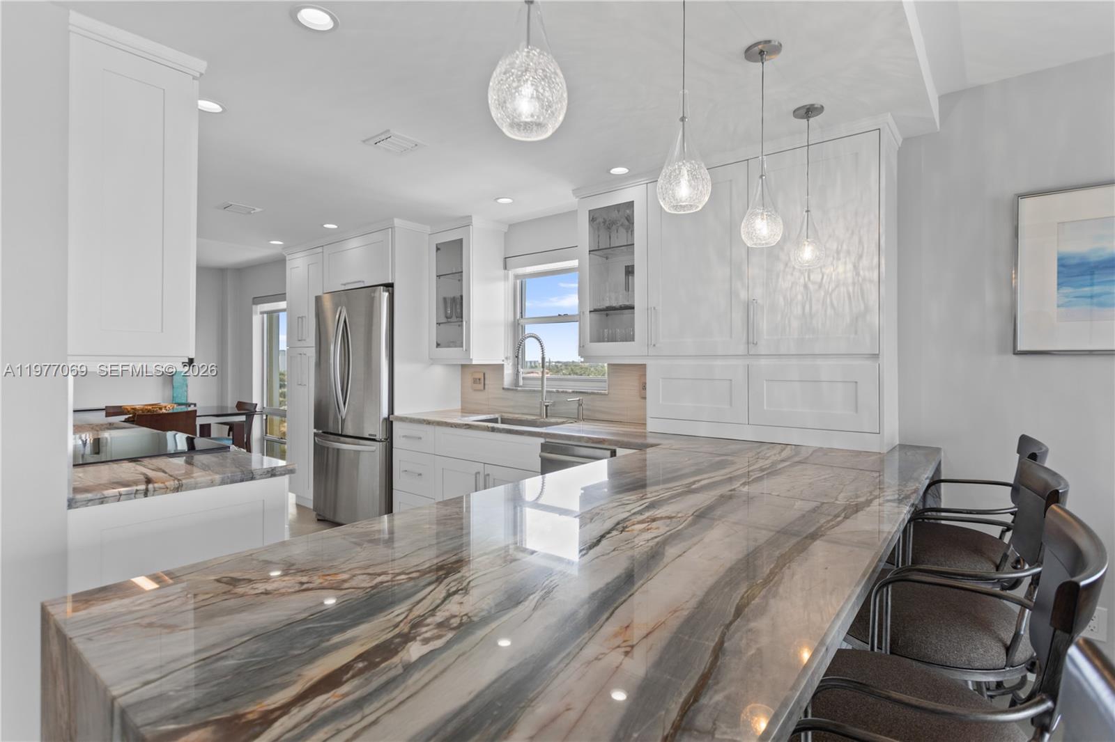 2611 North Riverside Drive, Unit 901 Pompano Beach, FL 33062 - Photo 8 of 27 a kitchen with stainless steel appliances granite countertop a stove and a refrigerator