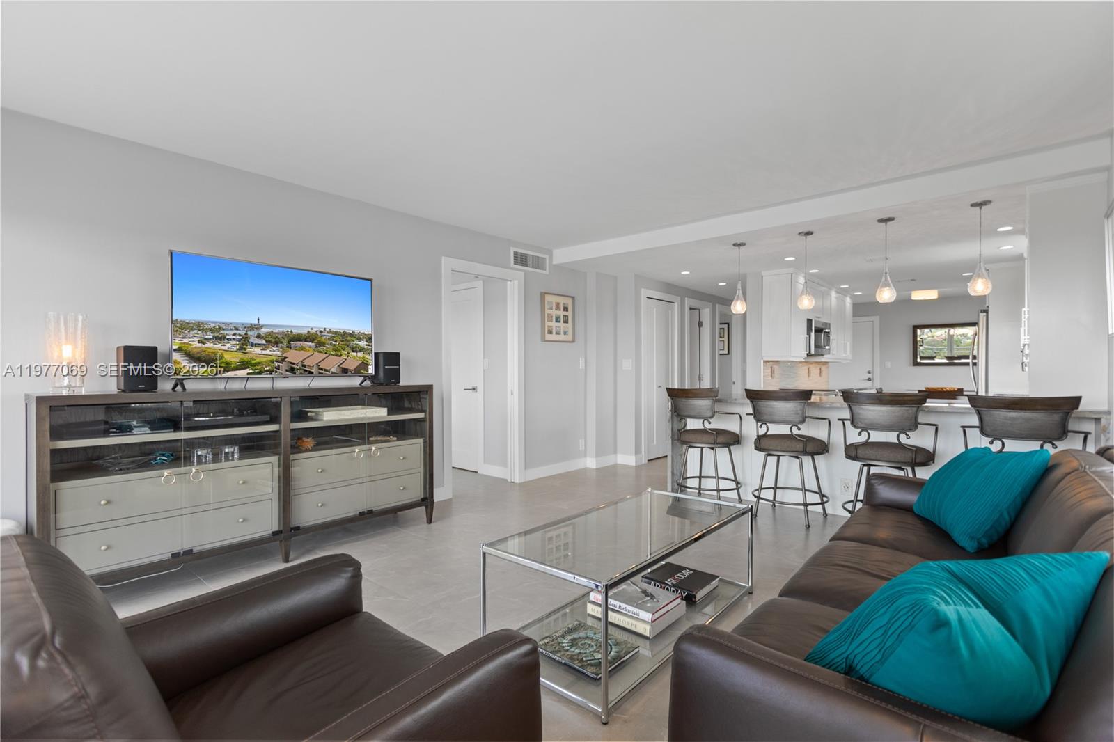 2611 North Riverside Drive, Unit 901 Pompano Beach, FL 33062 - Photo 10 of 27 a living room with furniture and a view of kitchen