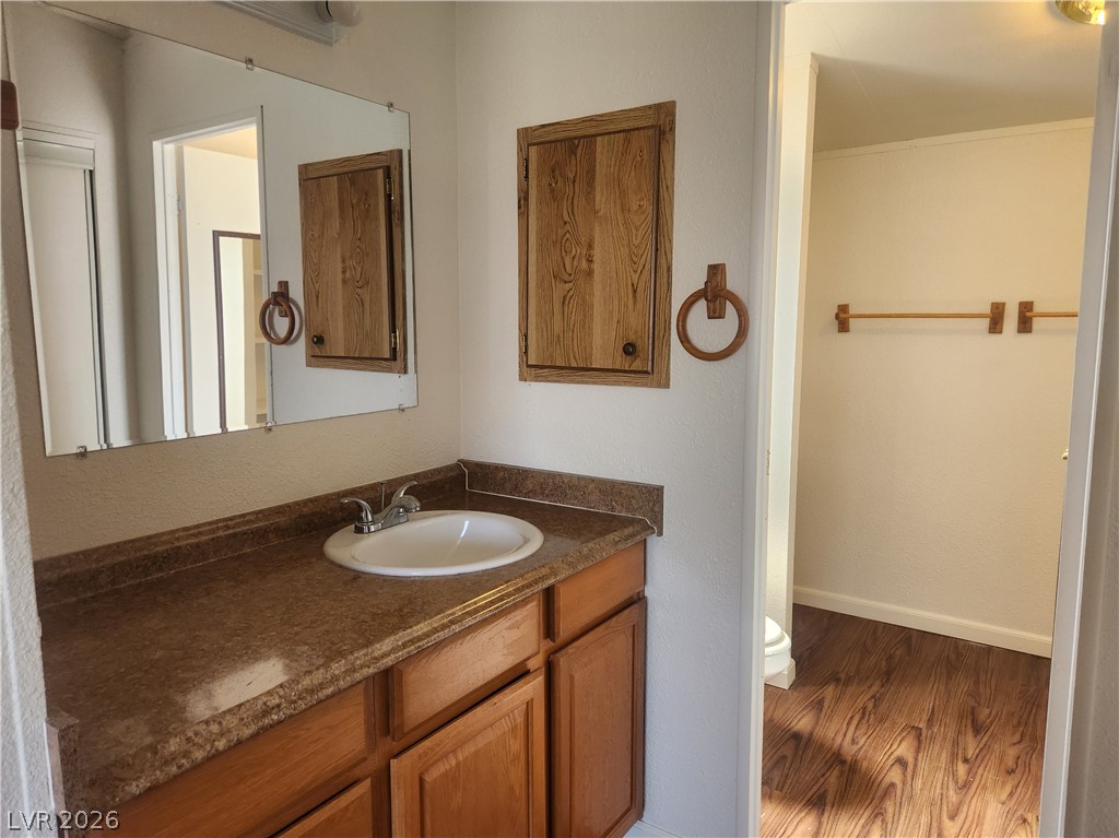 3189 Del Monte Street Laughlin, NV 89029 - Photo 16 of 32 A classic sink vanity with ample countertop space and a large mirror defines this functional bathroom.