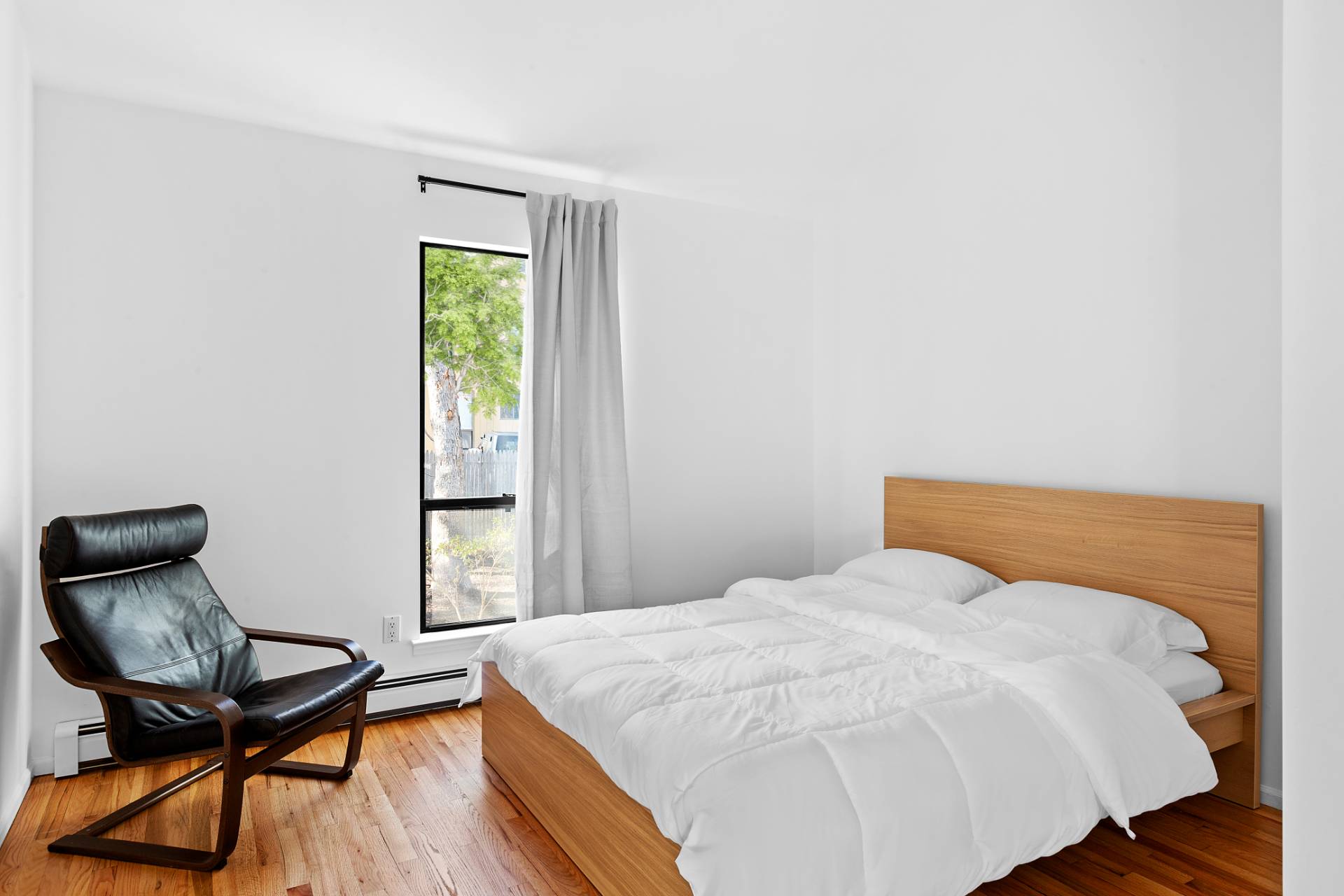 74 Hildreth Place East Hampton, NY 11937 - Photo 13 of 14 a bedroom with a bed and a chair