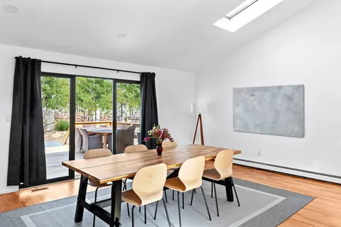 a view of a dining room with furniture window and wooden floor