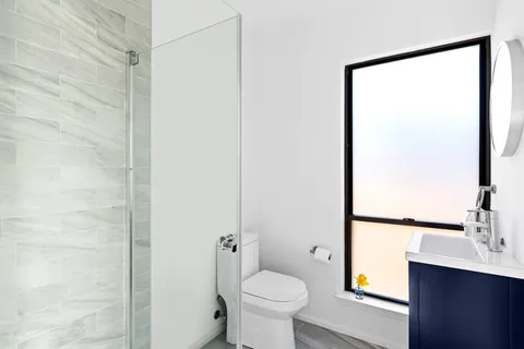 a bathroom with a toilet sink and a mirror