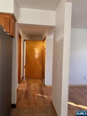 a view of a hallway with wooden shelves