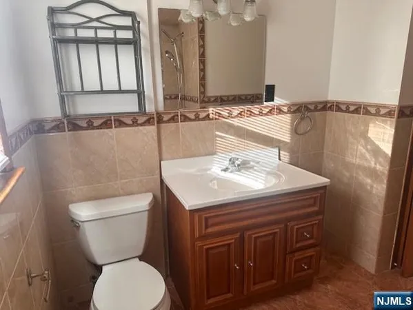 a bathroom with a sink a toilet and mirror