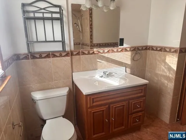 a bathroom with a sink a toilet and mirror