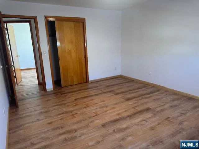 a view of a room with wooden floor and stairs