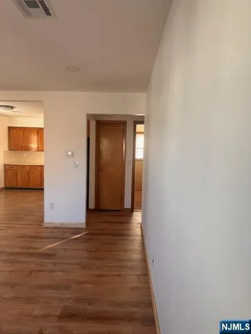 a view of hallway with wooden floor