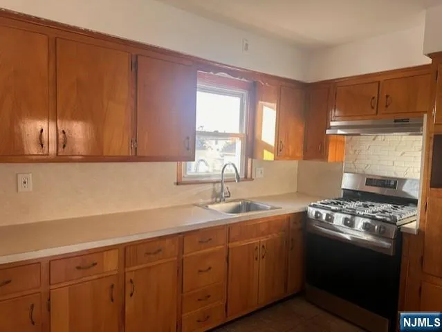 a kitchen with sink cabinets and window