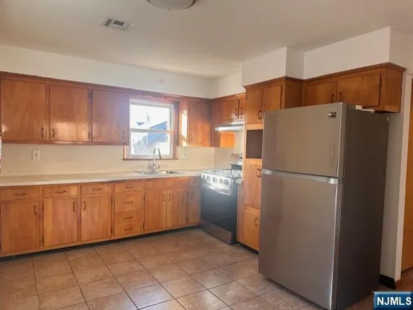 a white refrigerator freezer sitting inside of a kitchen