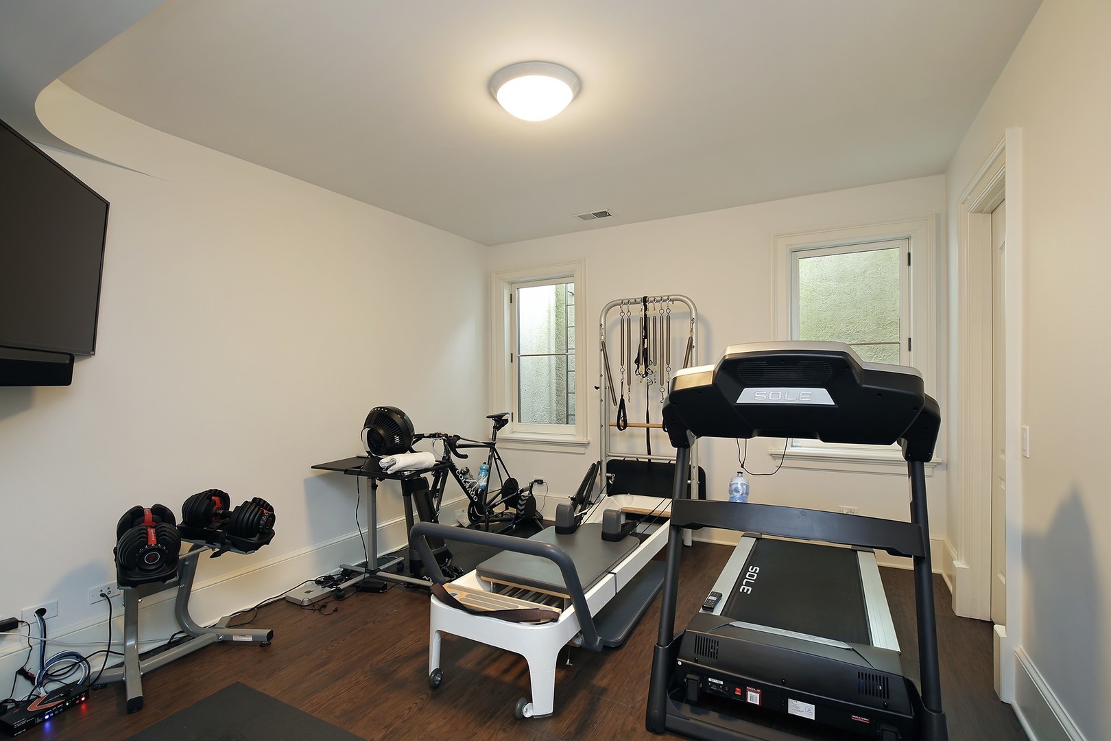 127 Old Green Bay Road Winnetka, IL 60093 - Photo 25 of 33 a room with gym equipment and a flat screen tv