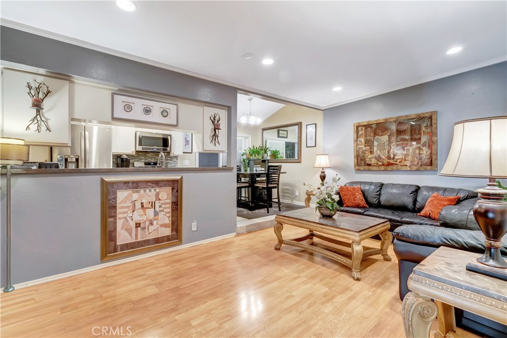 a living room with furniture and paintings on the wall