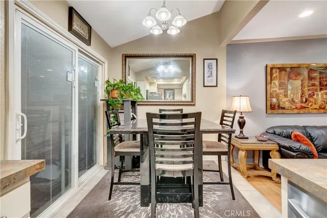 a view of a dining room with furniture and a chandelier