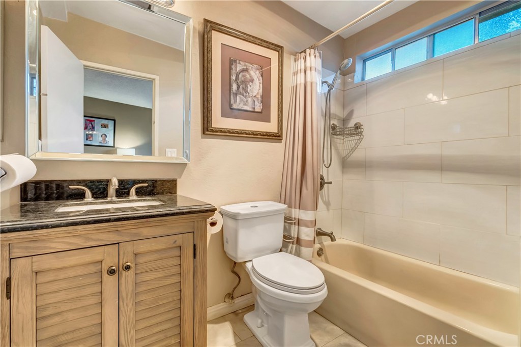 1523 East Windsor Road, Unit 208A Glendale, CA 91205 - Photo 15 of 27 a bathroom with a granite countertop toilet sink and mirror