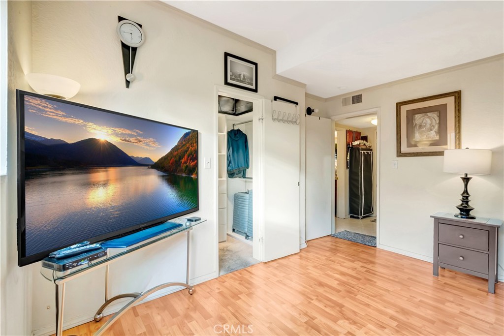 1523 East Windsor Road, Unit 208A Glendale, CA 91205 - Photo 18 of 27 a bedroom with a bed and a flat screen tv