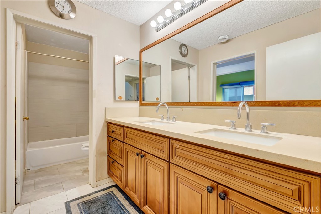 1523 East Windsor Road, Unit 208A Glendale, CA 91205 - Photo 19 of 27 a bathroom with a sink a mirror and a bathtub