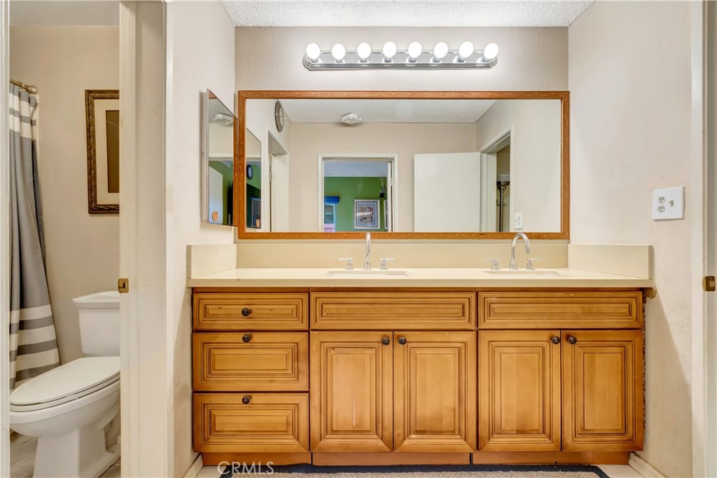 1523 East Windsor Road, Unit 208A Glendale, CA 91205 - Photo 20 of 27 a bathroom with a sink a toilet and a mirror