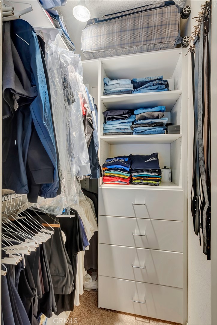 1523 East Windsor Road, Unit 208A Glendale, CA 91205 - Photo 25 of 27 a view of walk in closet with clothes and shoes