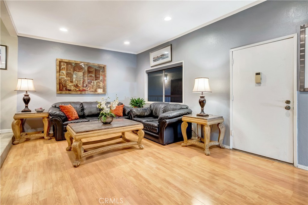 1523 East Windsor Road, Unit 208A Glendale, CA 91205 - Photo 4 of 27 a living room with furniture and a wooden floor