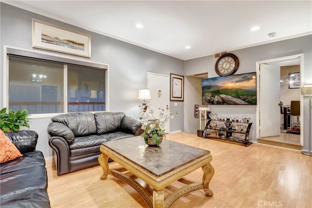 1523 East Windsor Road, Unit 208A Glendale, CA 91205 - Photo 6 of 27 a living room with furniture and wooden floor