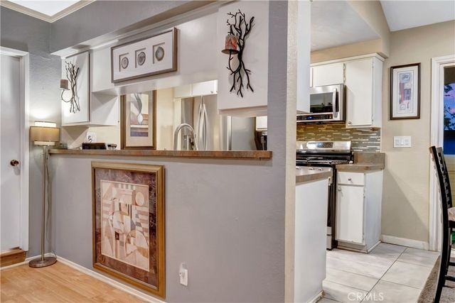 a kitchen with stainless steel appliances granite countertop a refrigerator and a stove