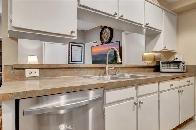a kitchen with a sink and a clock on the wall