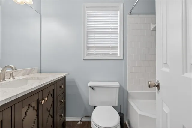 a bathroom with a sink a toilet and bathtub