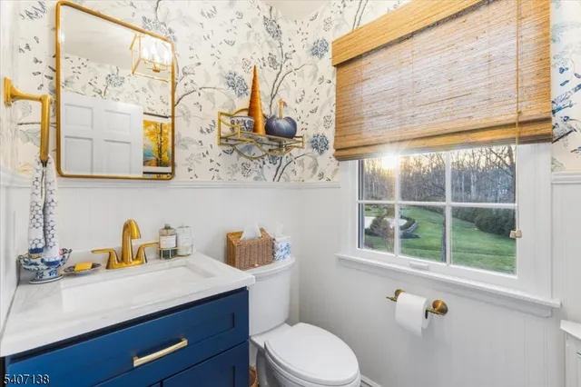 a bathroom with a sink a toilet and a window