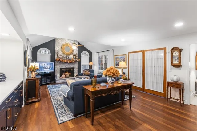 a living room with fireplace furniture and a large window