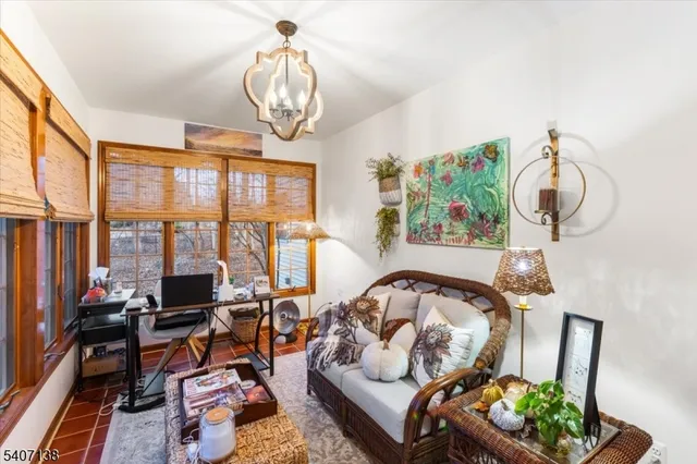 a living room with furniture chandelier and a large window