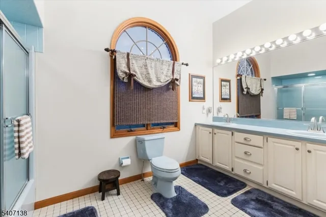 a bathroom with a toilet a sink and a mirror
