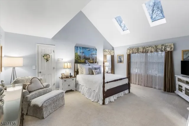 a bed room with furniture and a flat tv screen